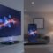 Illustration of a media app experience flowing across a smart TV, Android TV box, and smartphone with abstract streaming visuals and icon-only elements
